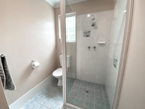 a bathroom with a shower and a toilet at Whitesands in Dunsborough