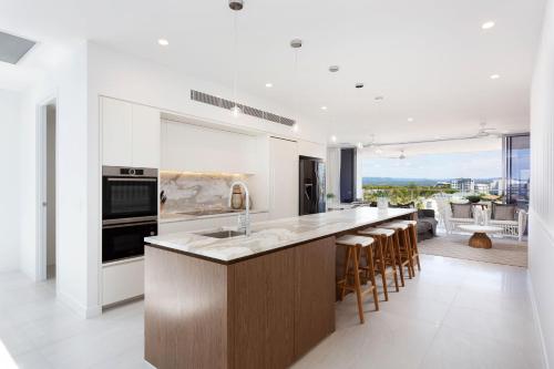 a kitchen with a large island with a counter top at The Beach Houses Holiday Villas in Gold Coast