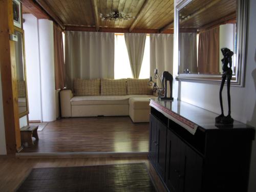 a living room with a couch and a table at Belloapartamento Ház Balatonkenese, Strand 800m, Jakuzzi in Balatonkenese