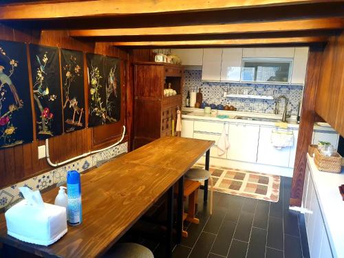 a kitchen with a wooden table in a room at Hanok1957 in Daegu