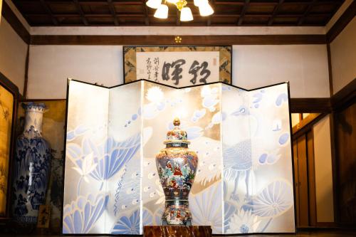 a vase sitting on a table in a room at Koyasan Shukubo Saizenin in Koyasan