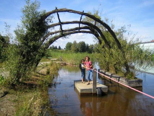 two people standing on a wooden bridge over a river at Prinzenhof in Grossgerungs