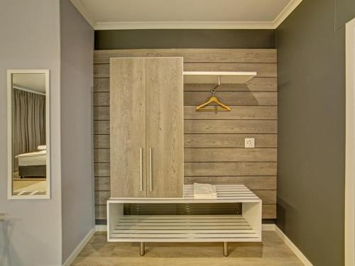 a room with a wooden wall with a bench at Atlantic Garden Boutique Hotel in Swakopmund