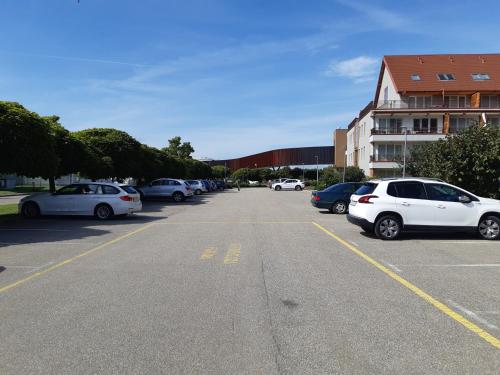 a parking lot with many cars parked in it at Apartmaji PANONIA "The Big Space" & "The Cozy Space" in Moravske Toplice