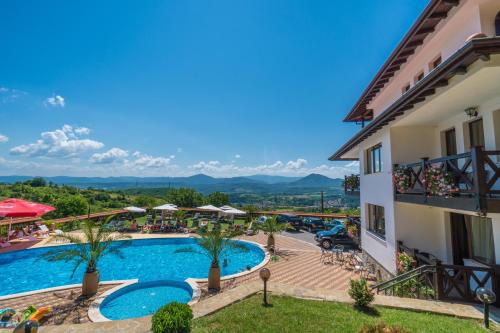 a resort with a swimming pool and a building at Complex Panorama in Elena