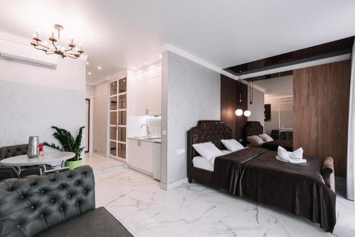 a bedroom with a bed and a living room at Royal Tower VIP Smart Apartments 2 in Kyiv