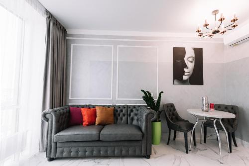 a living room with a couch and a table at Royal Tower VIP Smart Apartments 2 in Kyiv