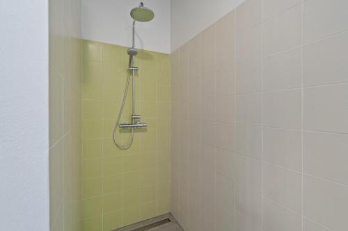 a shower with a shower head in a bathroom at Villa Vogelnest in Bressanone