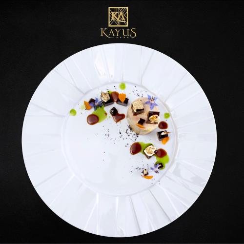a white plate with some food on top of it at Kayus in Buşteni