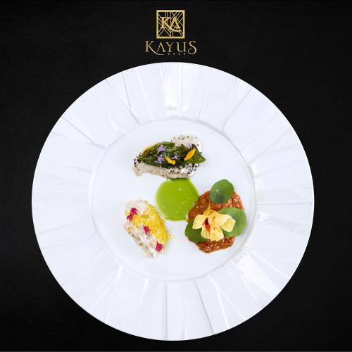 a white plate with different types of food on it at Kayus in Buşteni