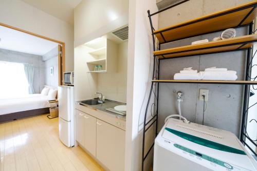 Postel nebo postele na pokoji v ubytování NAHA-WEST INN