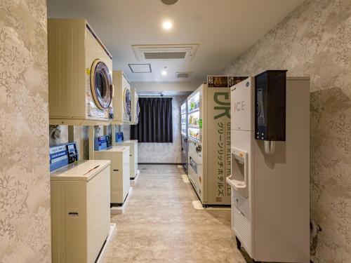 a kitchen with white appliances and a refrigerator at Green Rich Hotel Kobe Sannomiya (Artificial hot spring Futamata Yunohana) in Kobe