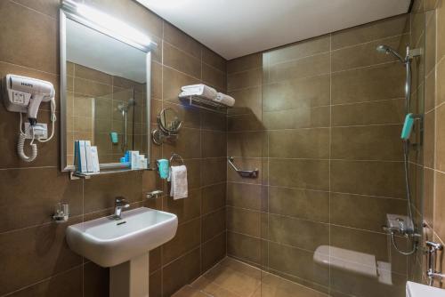 a bathroom with a sink and a shower at Boudl Al Jubail in Al Jubail