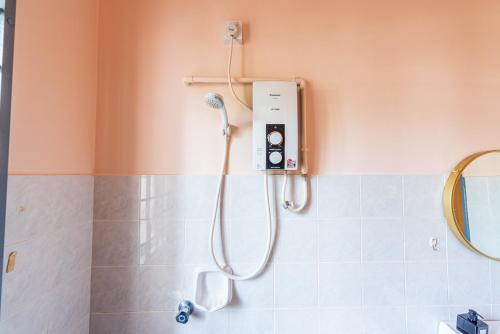 a shower in a bathroom with a shower head at 3BR Retreat Homestay near to GoldCoast, Sepang by Verano in Sungai Pelik