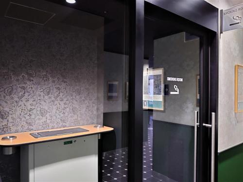 a bathroom with a shower with a counter in it at Green Rich Hotel Kobe Sannomiya (Artificial hot spring Futamata Yunohana) in Kobe
