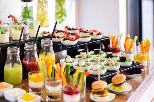 a buffet of food with appetizers and drinks on display at ACHAT Hotel Braunschweig in Braunschweig