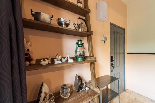 a kitchen with wooden shelves on the wall at 3BR Retreat Homestay near to GoldCoast, Sepang by Verano in Sungai Pelik
