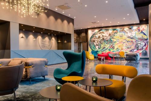 a living room filled with lots of furniture at Motel One Leipzig-Post in Leipzig