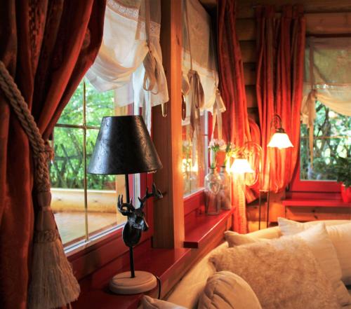 a lamp in a room with a window at Chalet mit Schlossblick Wernigerode, Chalet 2 in Wernigerode