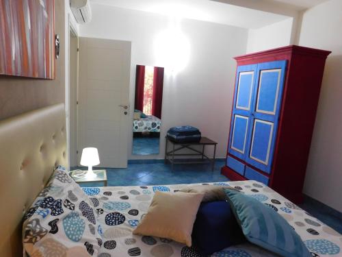 a bedroom with a bed and a door at Case Vacanza Elisir in Favignana