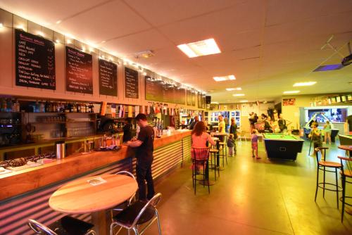 a group of people standing at a bar in a restaurant at Mobil Home XXL 4 chambres - Camping Les Viviers in Claouey