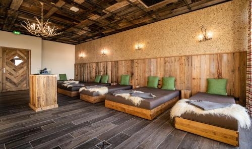 a row of beds in a room with wooden walls at Das Weitblick Allgäu in Marktoberdorf