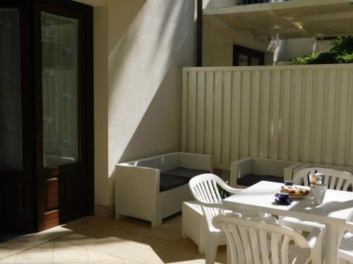 a patio with a table and chairs and a table and a table and chairsktop at Case Vacanza Elisir in Favignana