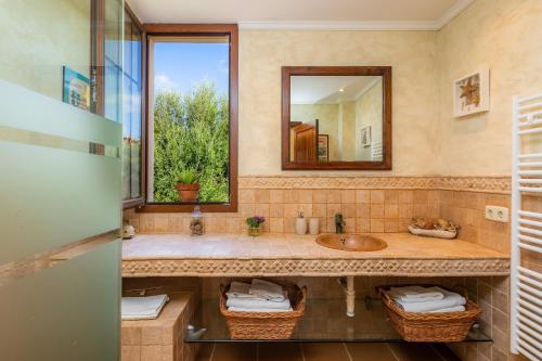 a bathroom with a sink and a mirror at Estrella in Son Serra de Marina