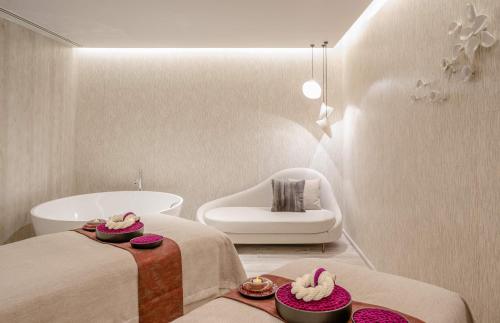 a bathroom with two beds and a bath tub at Kimpton Maa-Lai Bangkok, an IHG Hotel in Bangkok