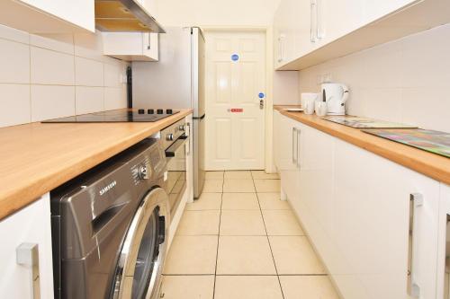 a kitchen with a washer and dryer at Townhouse @ 178 Ruskin Road Crewe in Crewe