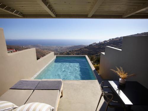 a view of a swimming pool from a house at Aeolis Tinos Suites in Tinos