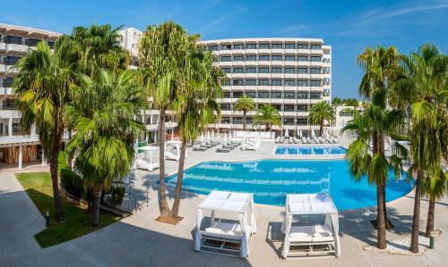 an image of a hotel with a pool and palm trees at INNSiDE by Meliá Alcudia in Port d'Alcudia