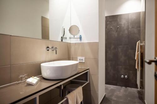 a bathroom with a sink and a mirror at Post Hotel - Tradition & Lifestyle Adults Only in San Candido