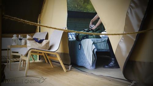 a person standing in a tent with a suitcase at Glamping Pian delle Ginestre in Sassetta