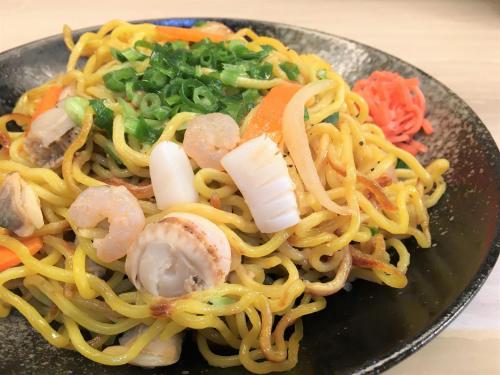 a plate of pasta with shrimp and vegetables at Hotel Wing International Sapporo Susukino in Sapporo