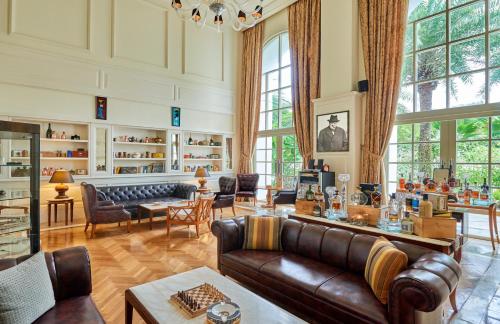 a living room with a couch and a table at The Danna Langkawi - A Member of Small Luxury Hotels of the World in Pantai Kok