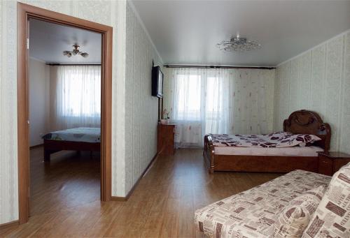 a room with two beds and a mirror in it at Двухкомнатная квартира с видом на Днепр в новом жилом комплексе! in Cherkasy
