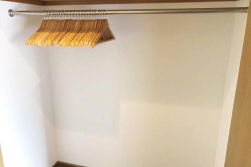 a broom hanging from a wall in a room at Chill Inn Honan in Tokyo