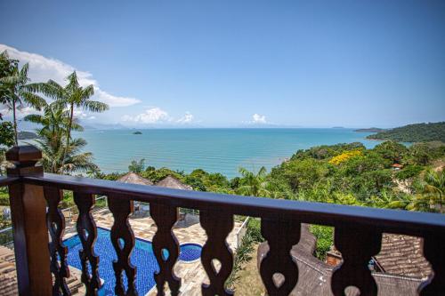 a view of the ocean from the balcony of a resort at Pousada Recanto de Paraty in Paraty