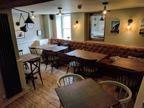 a row of tables and chairs in a restaurant at Royal Oak in Dover