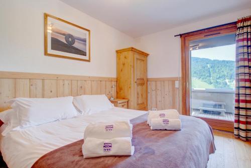 Ένα ή περισσότερα κρεβάτια σε δωμάτιο στο Croix Apartment - Snow and Trek - Morzine