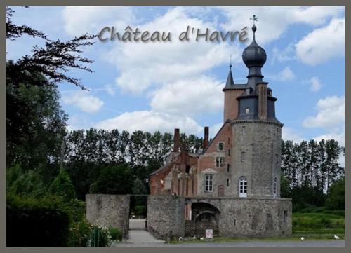 an old building with a tower on top of it at Hotel & Aparthotel Casteau Resort Mons Soignies in Casteau
