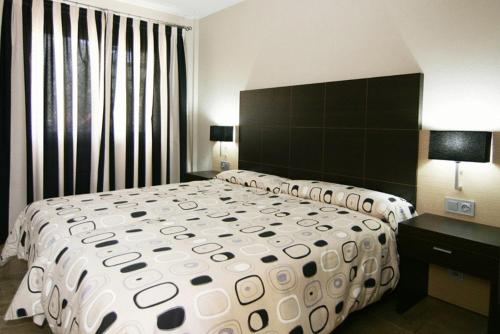 a bedroom with a large bed and a large window at Albir Palace in Albir