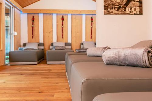 a living room with several couches in a room at Ruperti - Gästehaus in Ainring