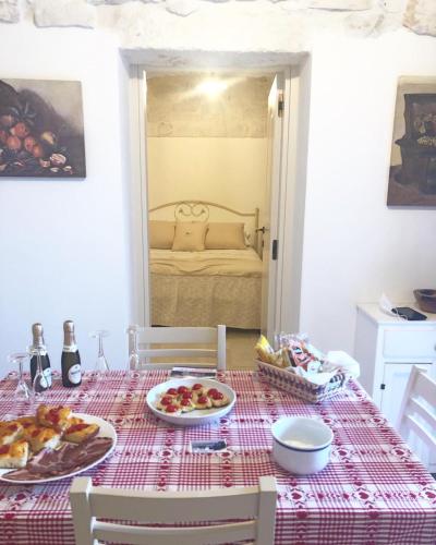 a dining room table with a red and white table cloth at TRULLI COLIBRI' in Locorotondo