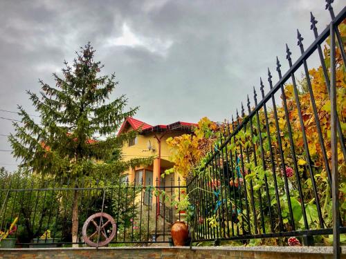 a wrought iron fence in front of a house at Pensiunea PORTAS RESORT in Slănic