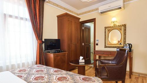 a hotel room with a large bed and a television at Best Western Empire Palace Hotel & Spa in Istanbul