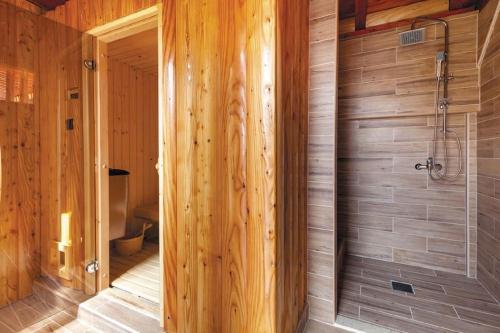 a bathroom with a shower in a wooden wall at Luxury villa Liberta near Split, private pool in Podstrana