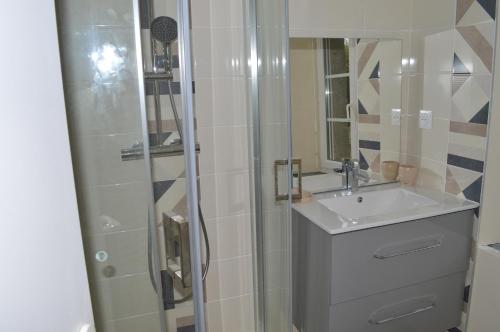 a bathroom with a sink and a shower at gite Marlotte in La Lande-Saint-Siméon