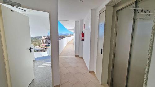 a hallway of a building with a view of a balcony at Infinity View Penthouses by NRAS in Arenales del Sol